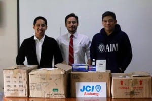 JCI Alabang RJ Paguyo and Yogs Villaruel receives the medicine donation from PACTS officer Jose Pastoral 